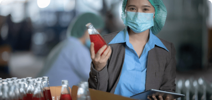 Worker working in industry factory for production of bottle water fruit drink. For Elements of HACCP.