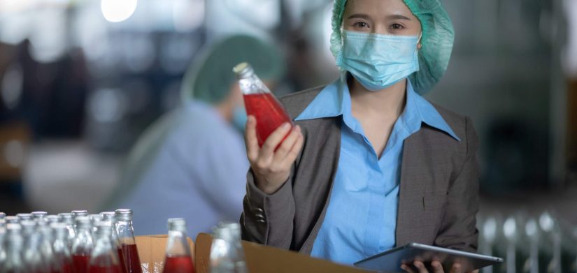 worker working in industry factory for production of bottle water fruit drink